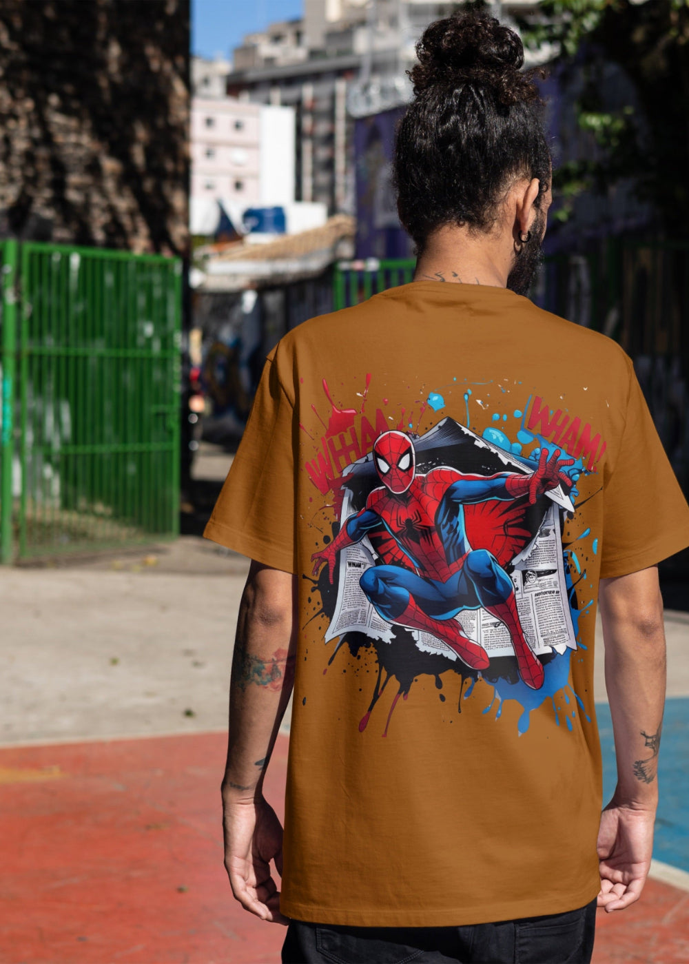 Person wearing a brown t-shirt with Spider-Man graphic on a street background