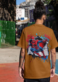 Person wearing a brown t-shirt with Spider-Man graphic on a street background