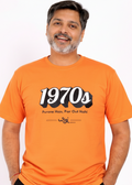 Man wearing an WYI orange t-shirt with '1970s' design on a white background
