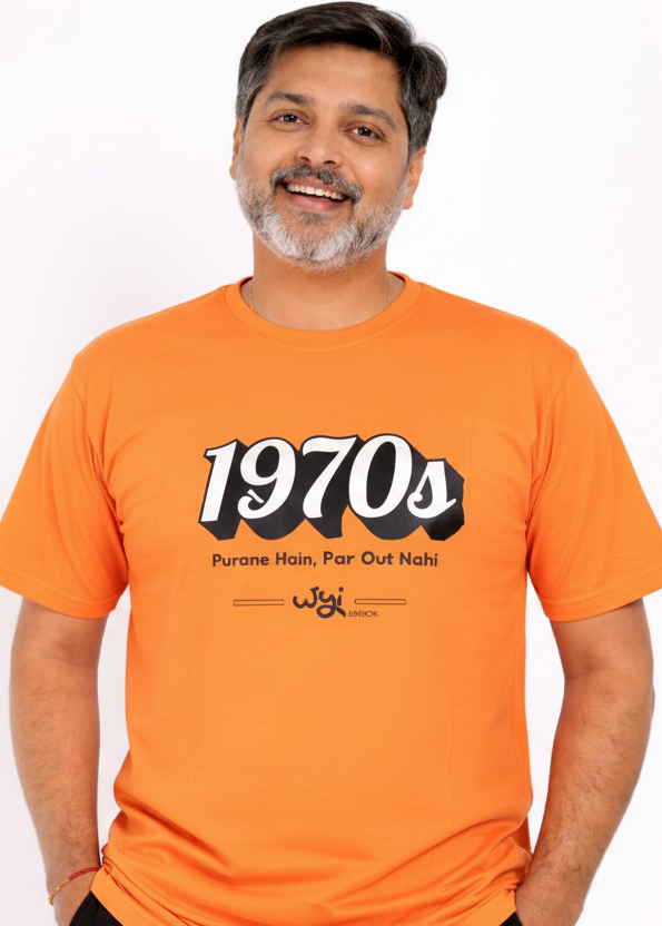 Man wearing an WYI orange t-shirt with '1970s' design on a white background