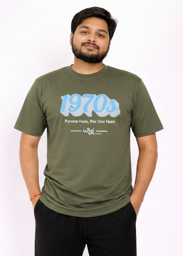 Man wearing a army green wyi t-shirt with '1970s' text design on a white background.