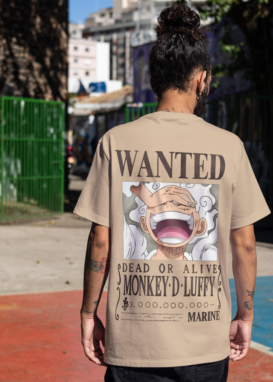 Person wearing a t-shirt with a 'Wanted' poster design, standing on a street.