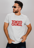 Man wearing a white t-shirt with 'TOKYO' printed in red on a plain background