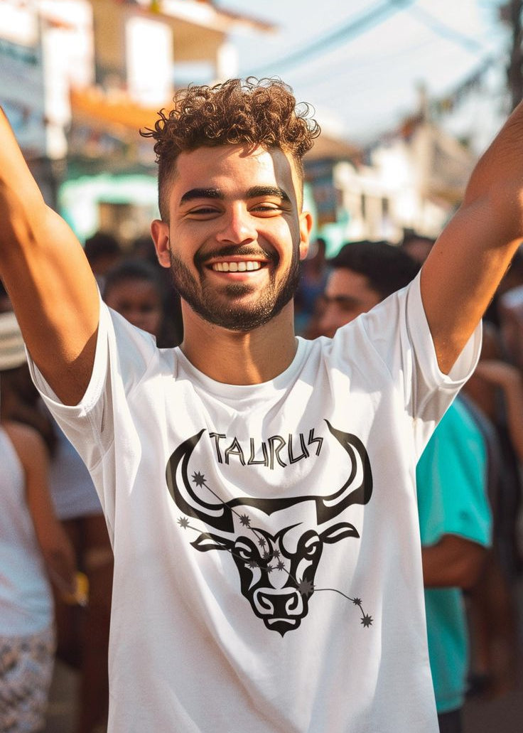 Man wearing a white t-shirt with a Taurus logo at an outdoor event.