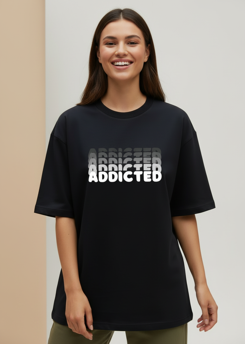 Black oversized WYI t-shirt with 'ADDICTED' printed on it against a brown background