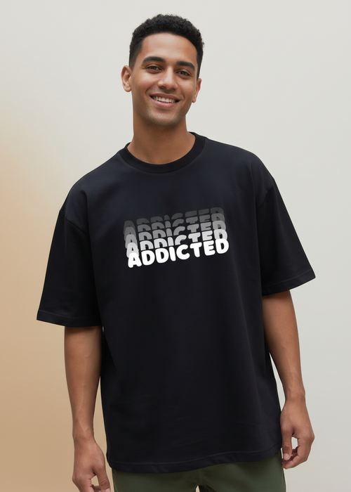 Black wyi t-shirt with 'ADDICTED' printed on it against a brown background