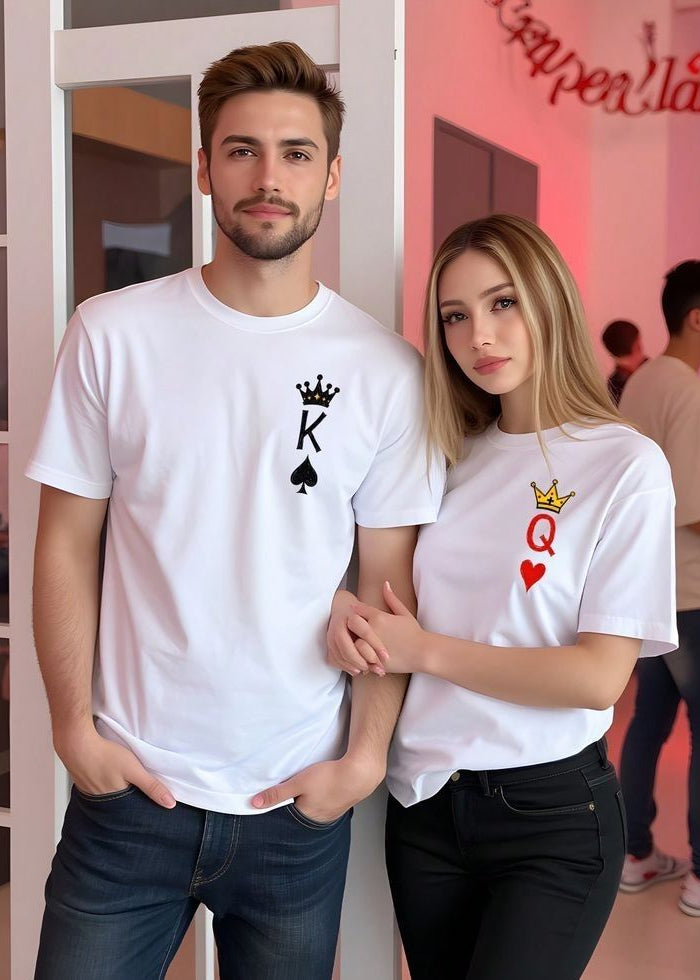 Man and woman wearing white t-shirts with King and Queen of Hearts designs, standing in a casual setting.