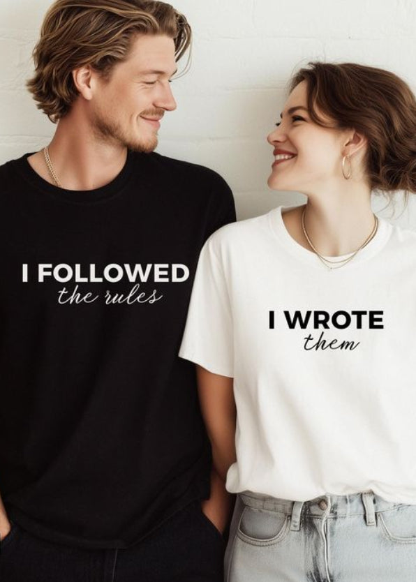 Two people wearing t-shirts with humorous text designs on a light background