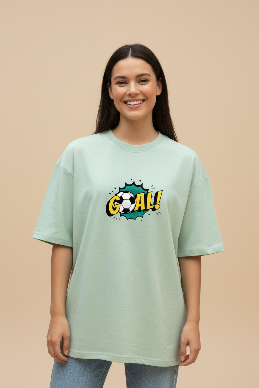 Woman wearing a WYI sage green t-shirt with a 'GOAL!' graphic on a beige background