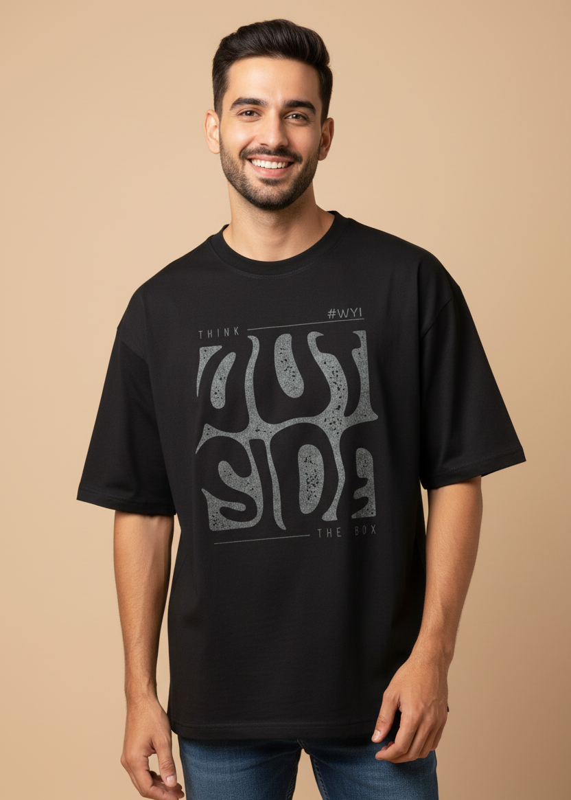 Male wearing a WYI black oversized t-shirt with graphic design in an indoor setting