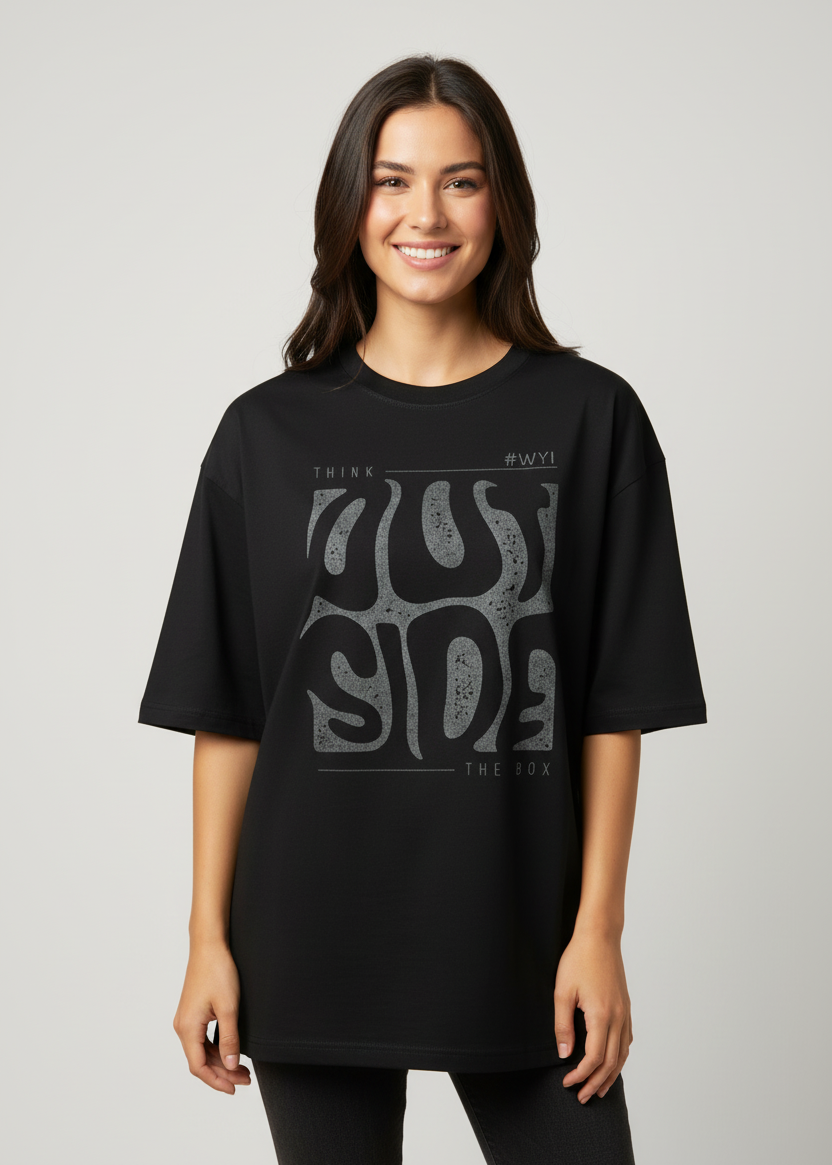 Female wearing a WYI black oversized t-shirt with graphic design in an indoor setting